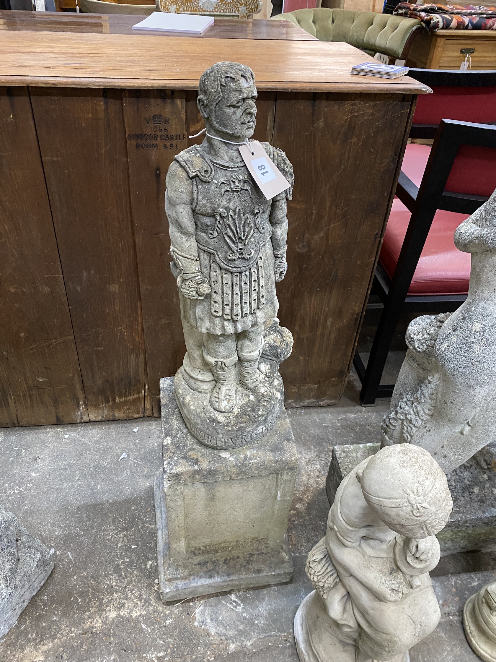 A reconstituted stone garden statue of a Roman centurion on square plinth, height 101cm